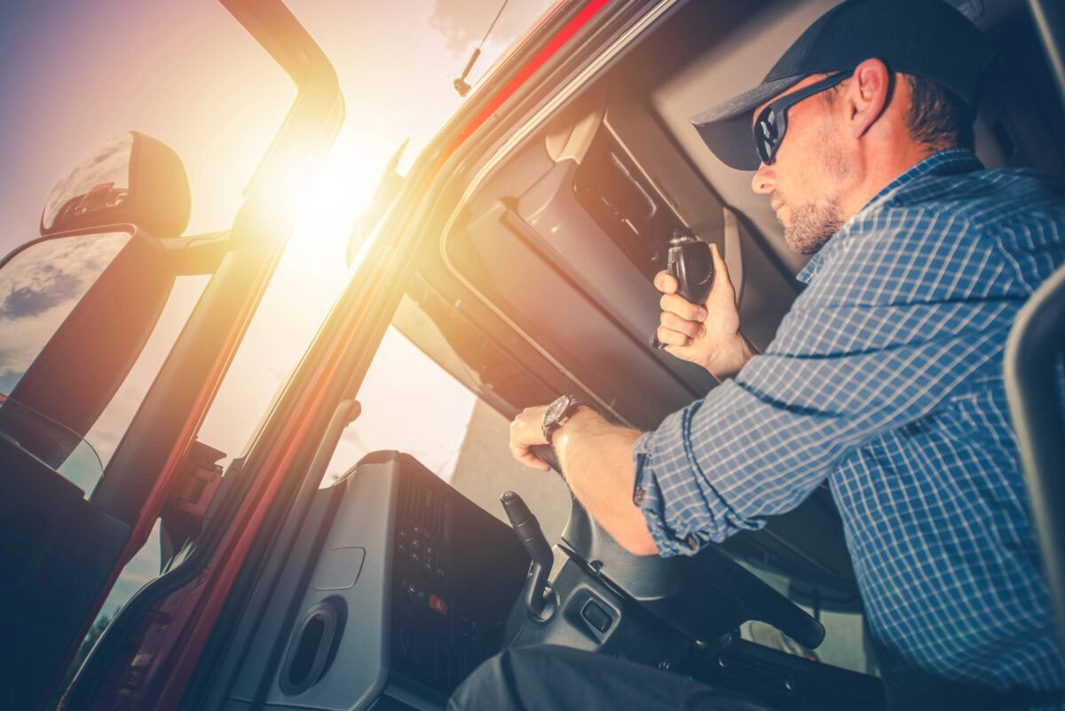 Trucker Preparing For Trip. Truck Driver Job. Caucasian Men Talking on CB Radio.