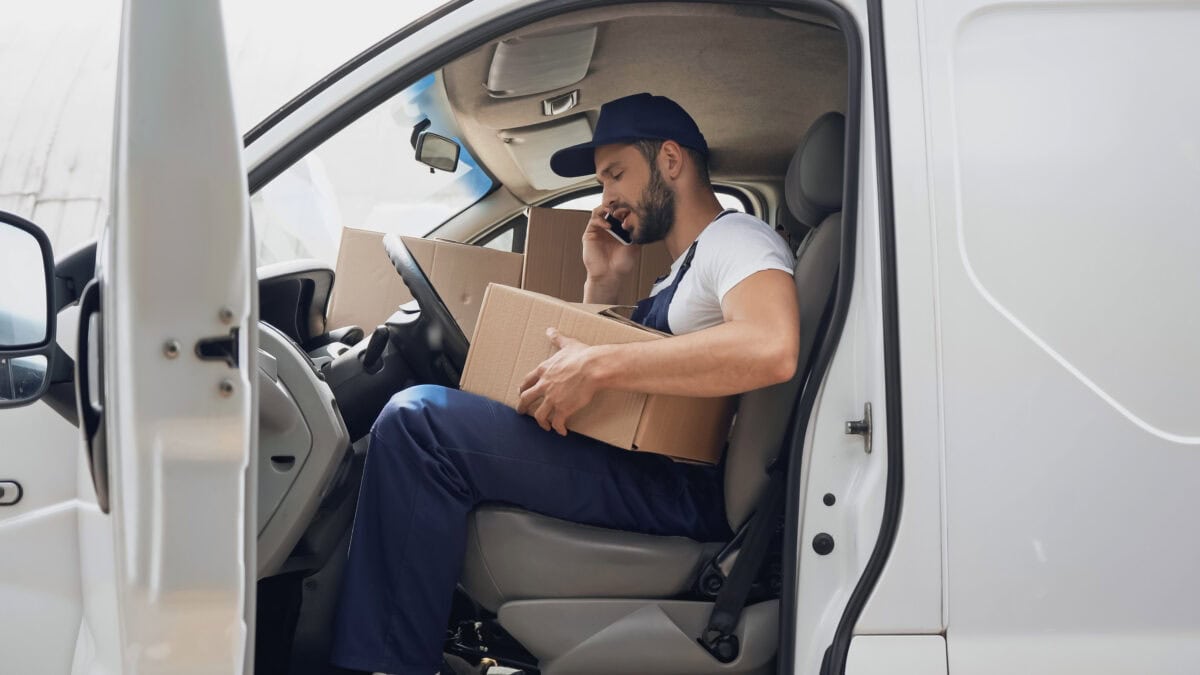 side view courier talking smartphone